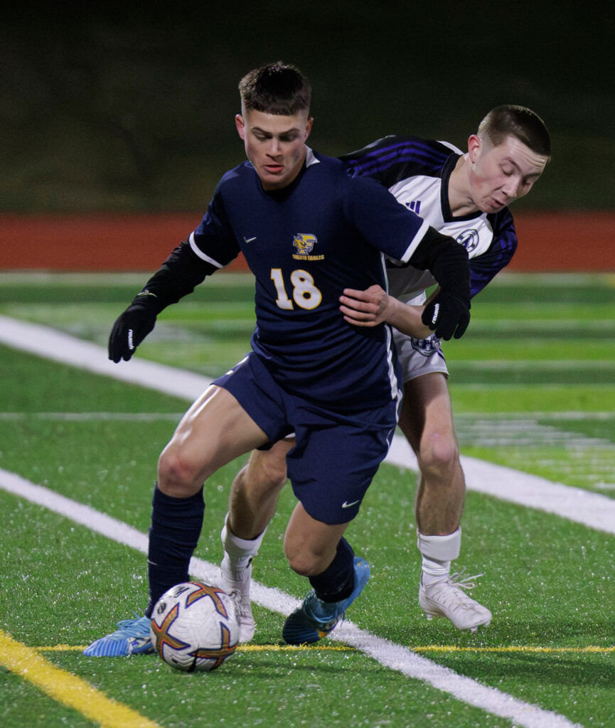 Ferndale's Ahanu Fasani is tackled to the ground by an Anacortes player as he goes for the ball.