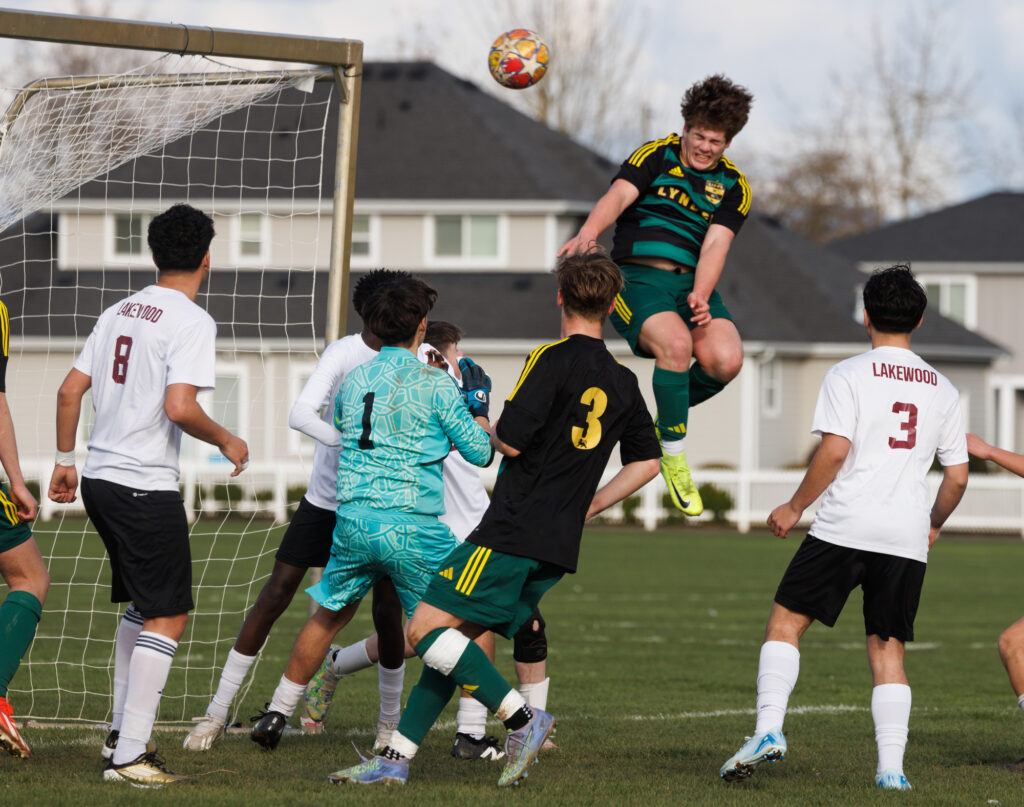 Lynden’s Malachi Koenen heads the ball on a corner kick against Lakewood for a goal.